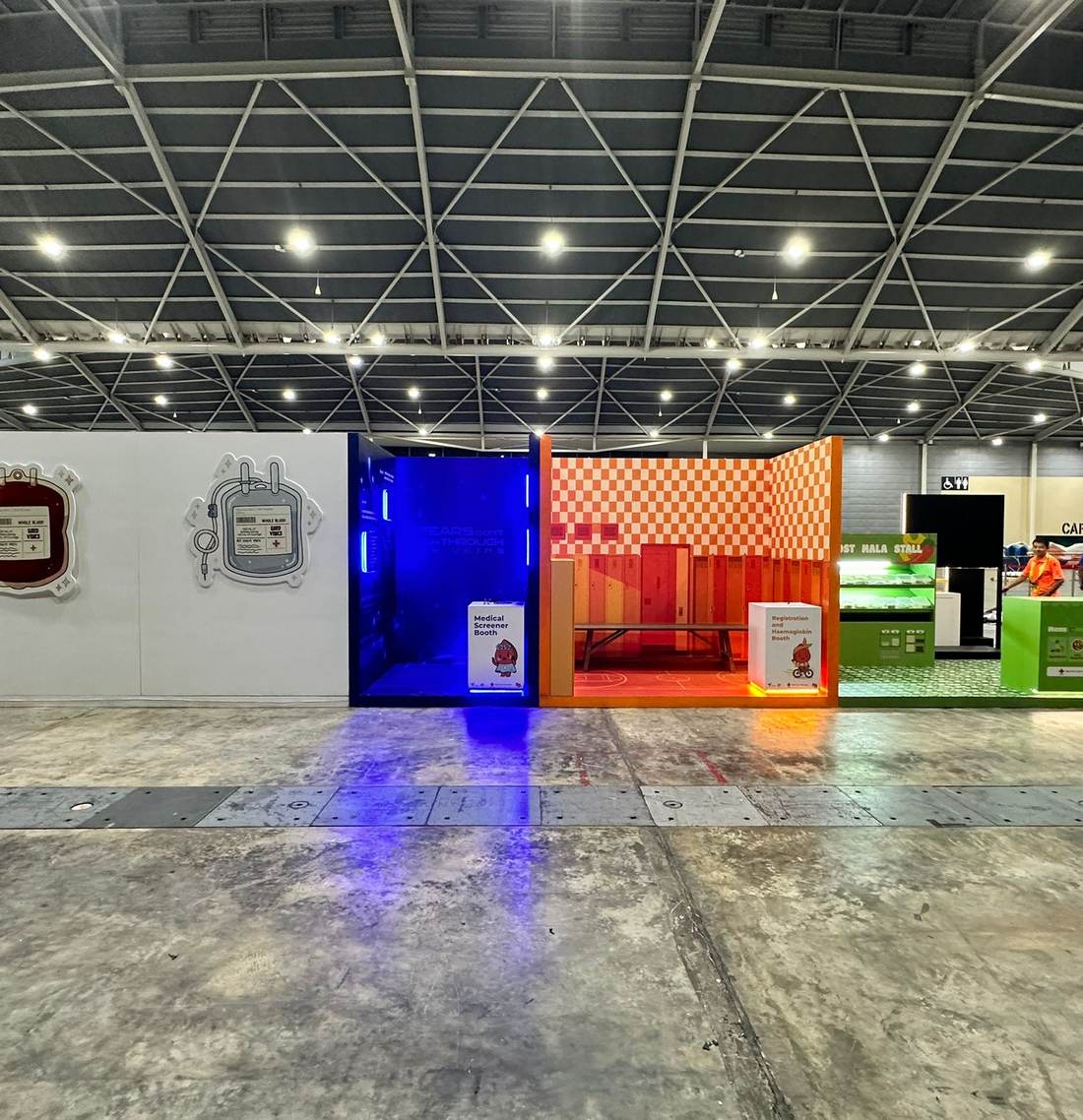 An exhibition hall with colourful booths set up for an event