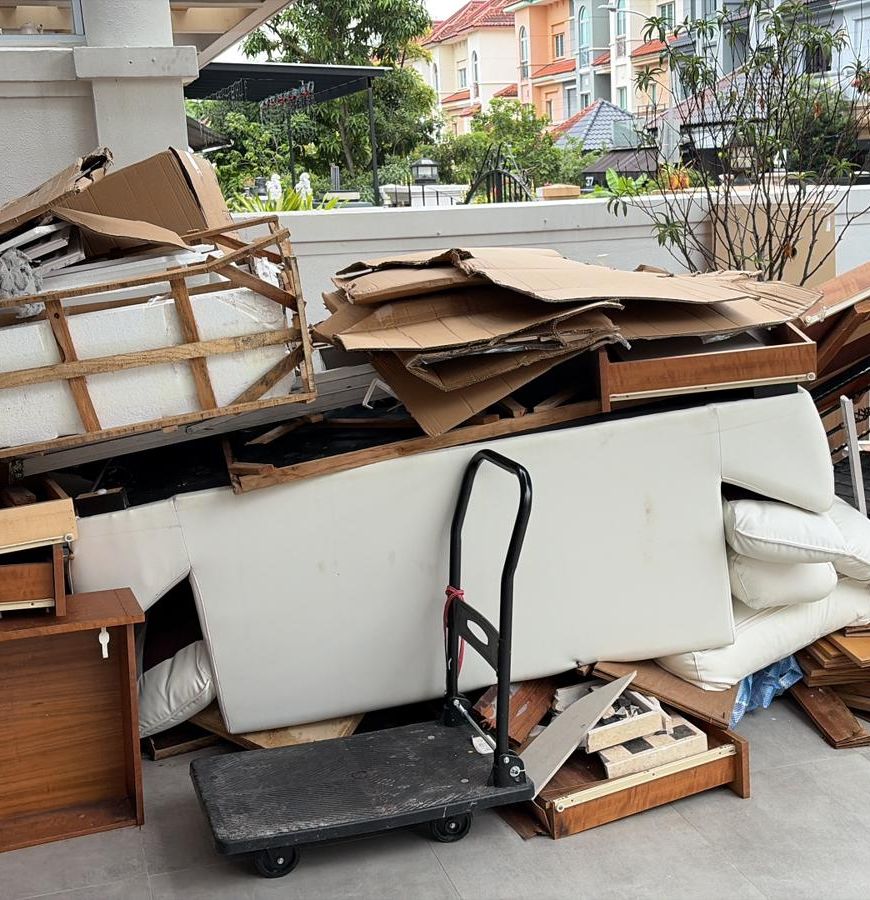 A pile of old wooden furniture and boards waiting to be cleared