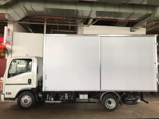 A white 15ft box lorry parked in a covered carpark