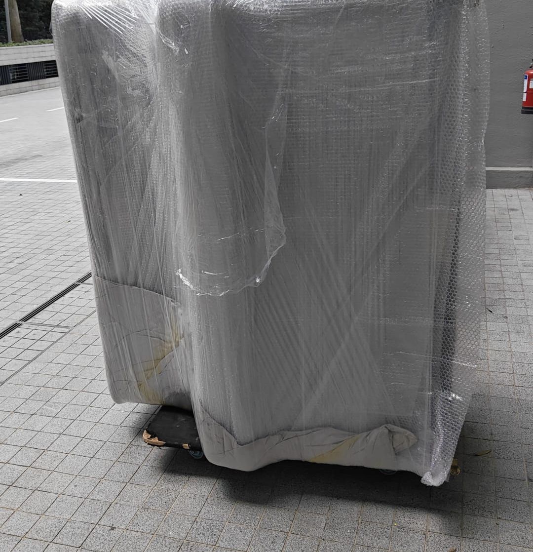 A wrapped piano ready to be moved