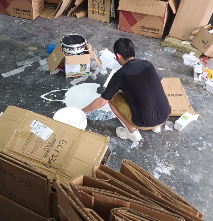 A JustGo team member sorting cartons and boards for disposal