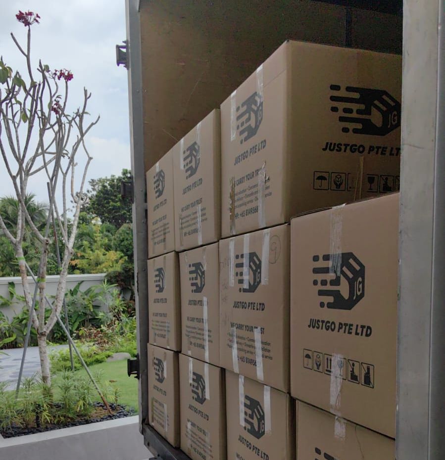 JustGo carton boxes stacked inside the back of a lorry