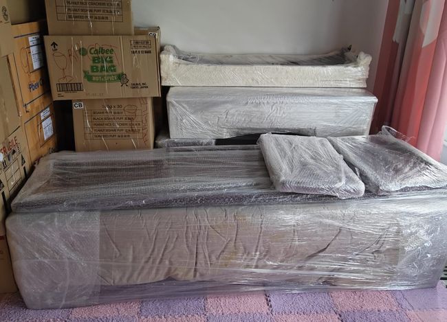 Wrapped mattresses and boxes ready for transport