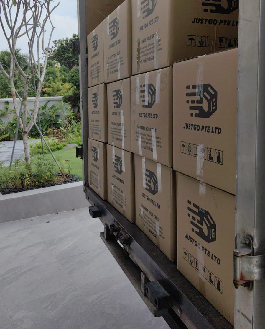 JustGo carton boxes stacked inside a lorry